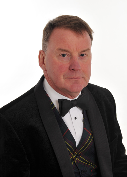 Willie Allan compossed in a suit