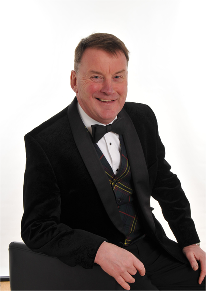 Willie Allan smiling in a suit