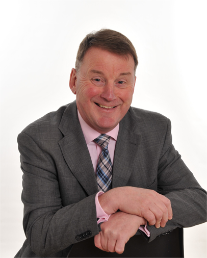 Willie Allan smiling in a suit